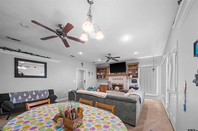 dining area with light carpet and ceiling fan