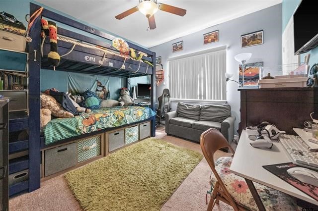 bedroom with ceiling fan and carpet floors