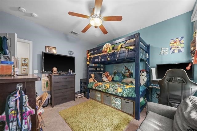 bedroom featuring ceiling fan and light carpet