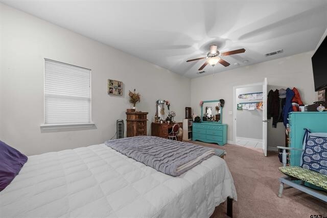 carpeted bedroom with ceiling fan