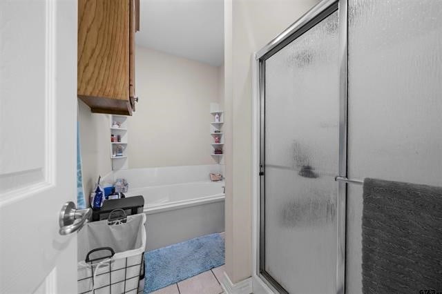 bathroom with tile patterned floors and plus walk in shower