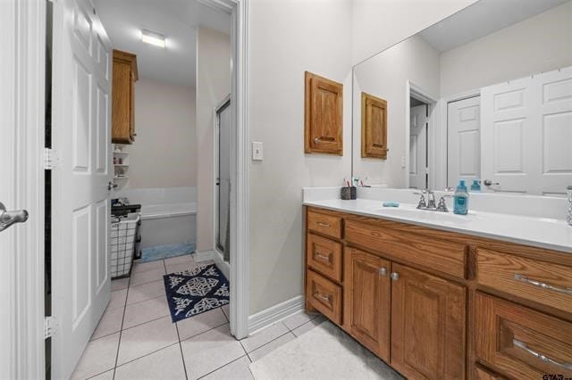 bathroom featuring tile patterned flooring, vanity, and independent shower and bath