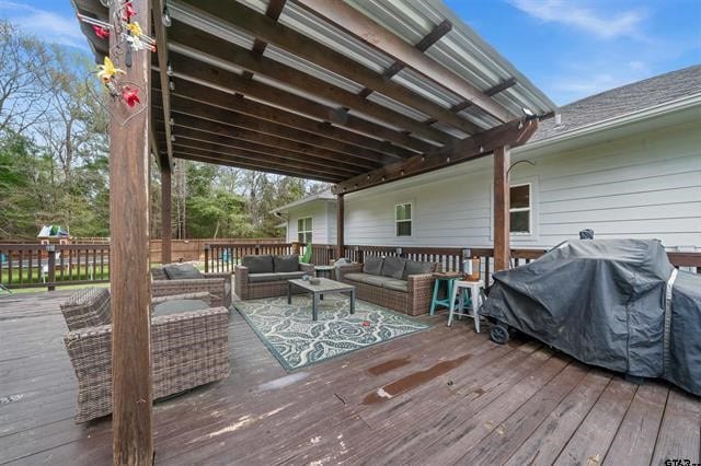 wooden terrace featuring an outdoor living space and a grill