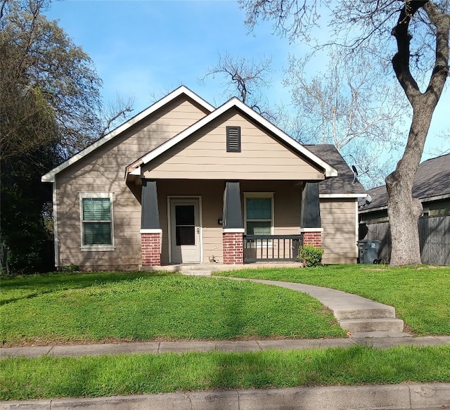 view of front facade with covered porch and a front yard