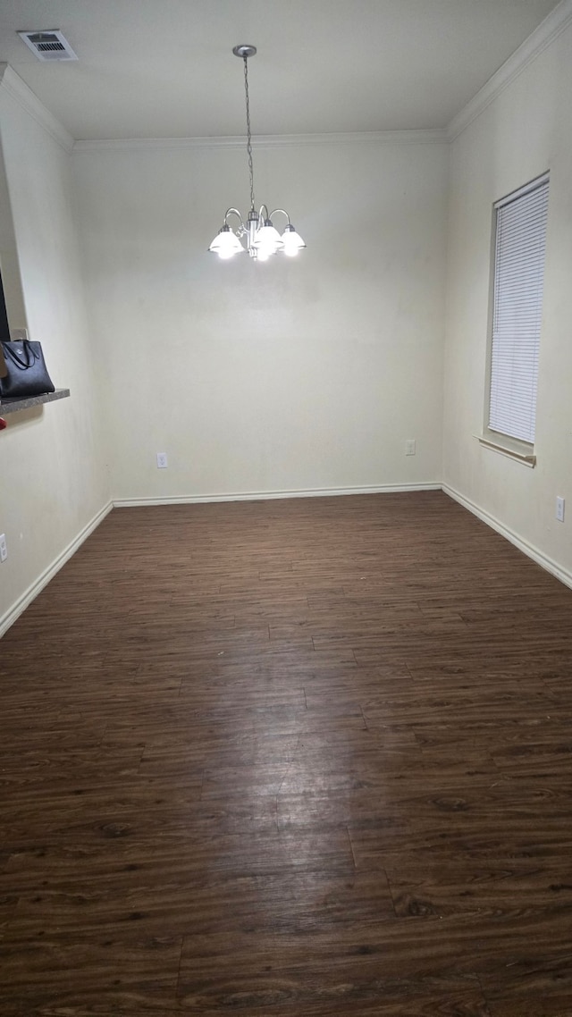 interior space with dark hardwood / wood-style floors, ornamental molding, and a chandelier