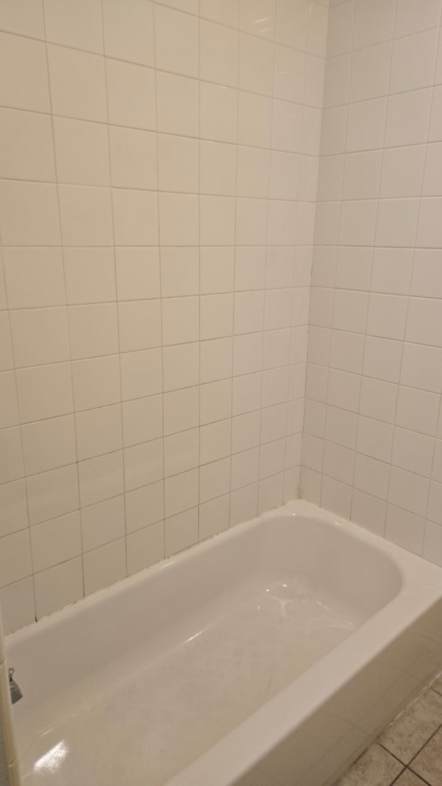 bathroom featuring tile patterned floors and a bathtub