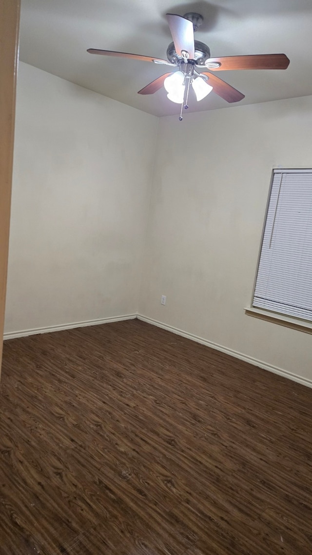 spare room with dark hardwood / wood-style floors and ceiling fan