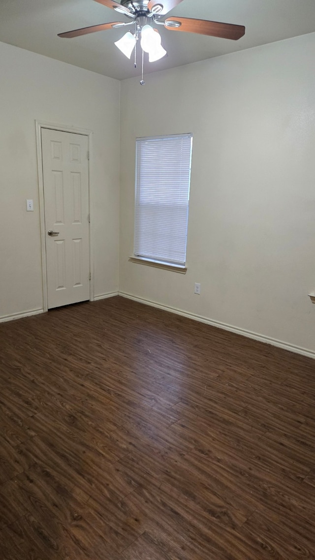 unfurnished room with ceiling fan and dark hardwood / wood-style flooring