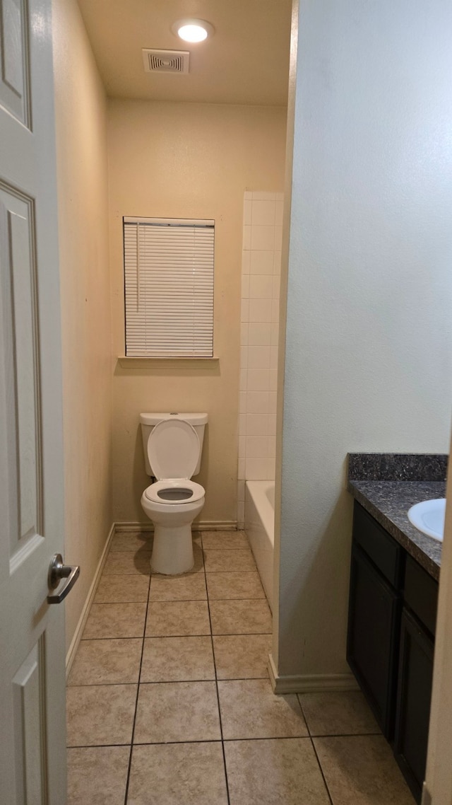 bathroom featuring tile patterned flooring, vanity, and toilet