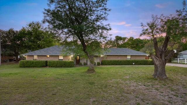 ranch-style house featuring a yard