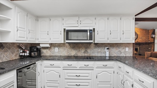 kitchen with white cabinets, tasteful backsplash, black appliances, and dark stone counters