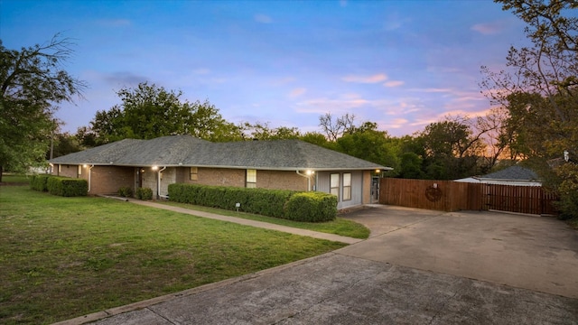 ranch-style home with a yard