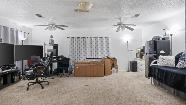 interior space with a textured ceiling, ceiling fan, and light colored carpet