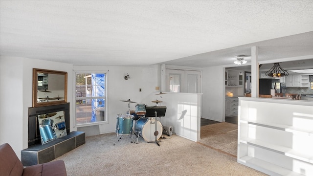 carpeted office featuring a textured ceiling