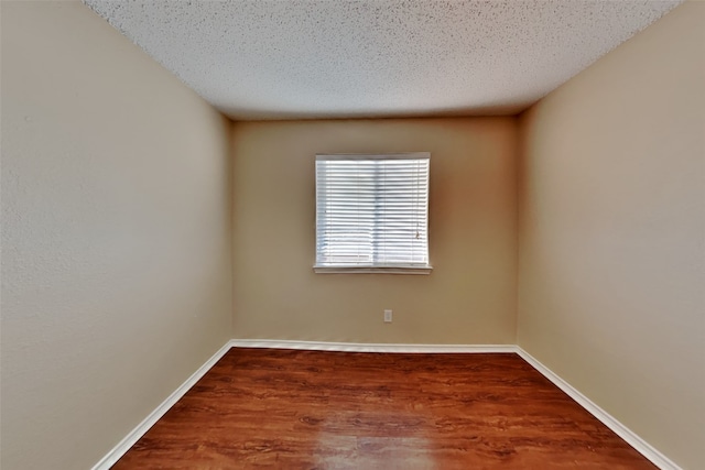 unfurnished room featuring a textured ceiling and hardwood / wood-style flooring