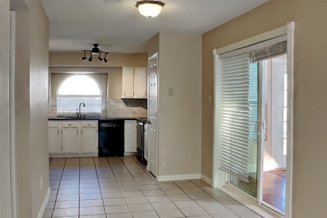 kitchen with black appliances, light tile patterned floors, tasteful backsplash, sink, and white cabinets