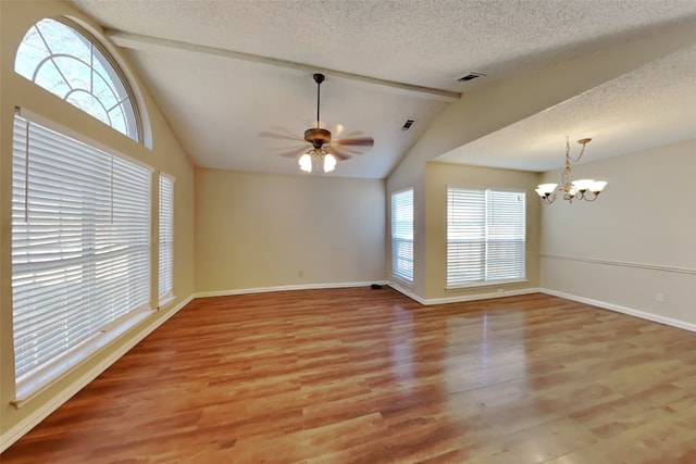 unfurnished room with a textured ceiling, vaulted ceiling, ceiling fan with notable chandelier, and hardwood / wood-style floors