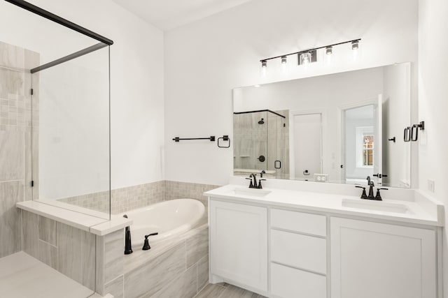 bathroom featuring vanity and shower with separate bathtub