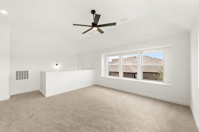 interior space featuring ceiling fan, carpet flooring, and vaulted ceiling