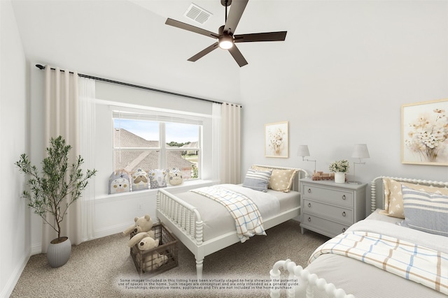 carpeted bedroom with ceiling fan and a high ceiling