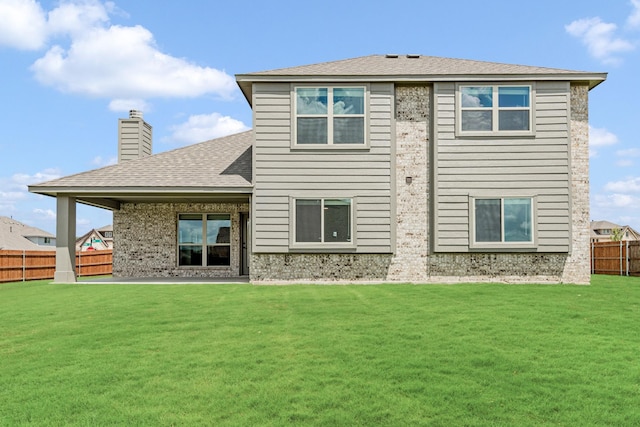 rear view of property featuring a yard