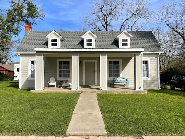 view of front of house featuring a front lawn and covered porch