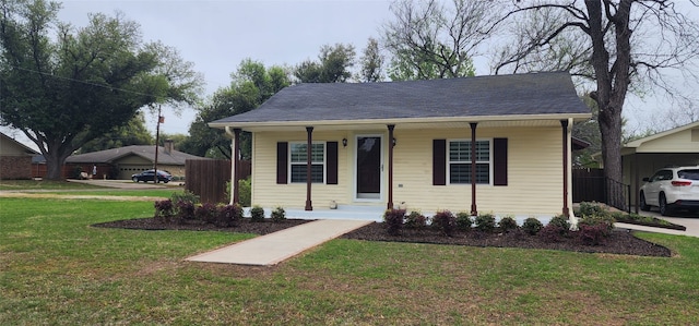 view of front of property with a carport and a front lawn