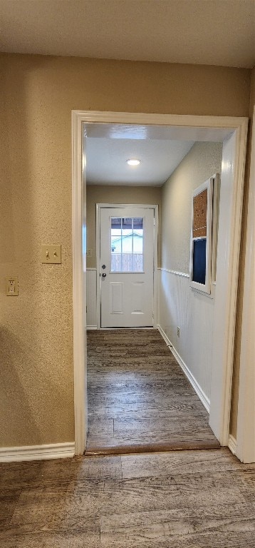 corridor featuring dark hardwood / wood-style flooring