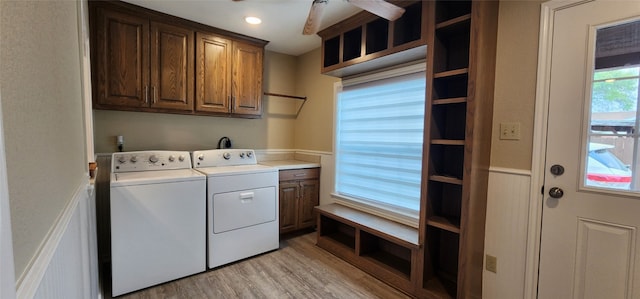 washroom with ceiling fan, cabinets, light wood-type flooring, and independent washer and dryer