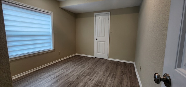 empty room featuring dark hardwood / wood-style flooring