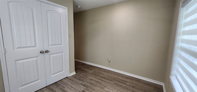 empty room featuring dark wood-type flooring