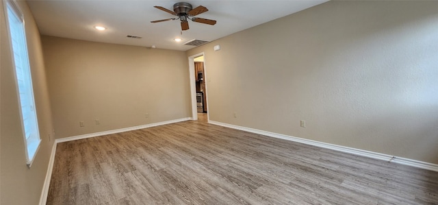 unfurnished room with ceiling fan and hardwood / wood-style floors