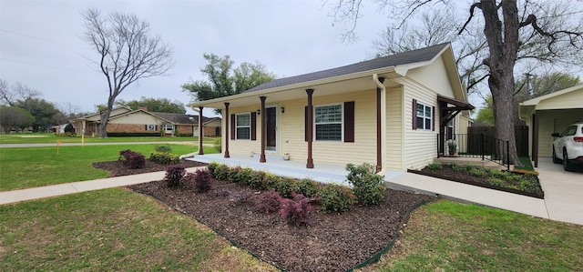 ranch-style house with a front yard, a carport, and covered porch