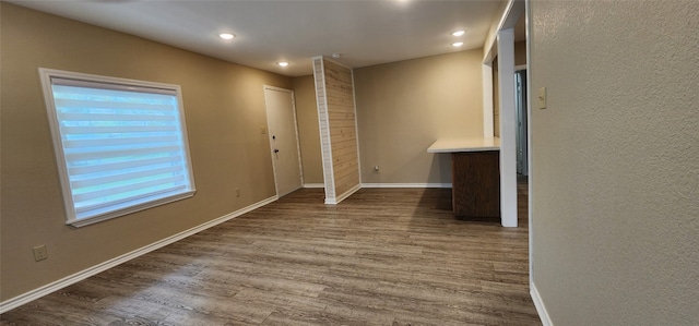 unfurnished bedroom with dark wood-type flooring