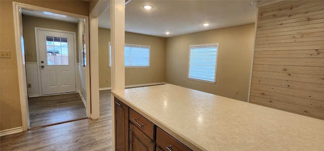 kitchen with wood-type flooring and wood walls