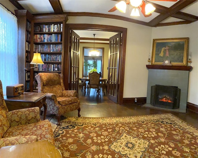 sitting room featuring beam ceiling, a healthy amount of sunlight, hardwood / wood-style flooring, and coffered ceiling