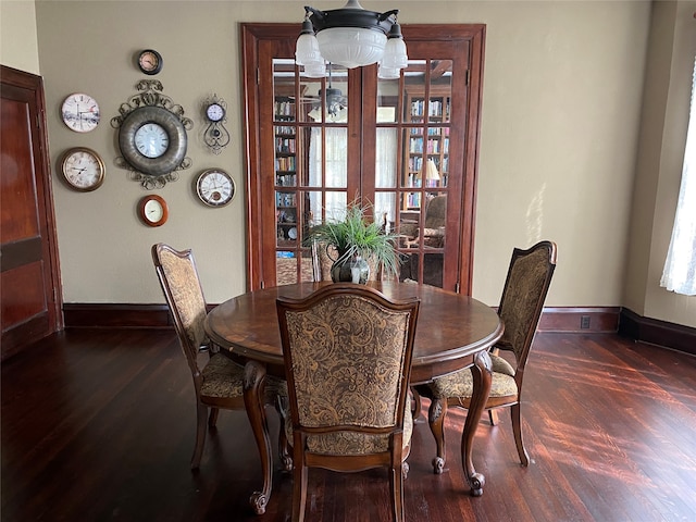 dining space with wood-type flooring