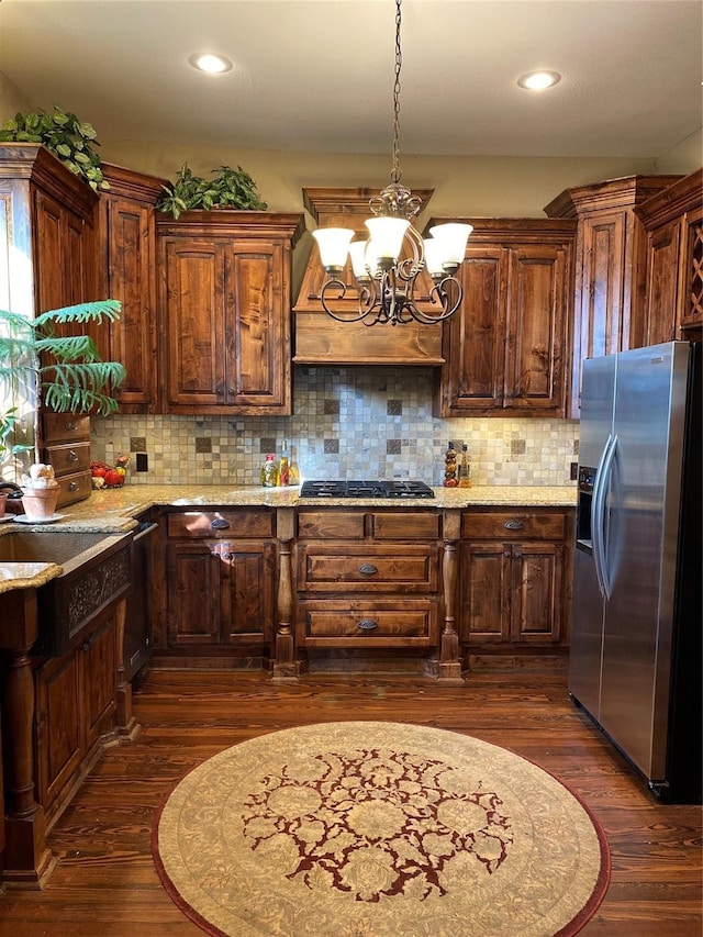 kitchen with backsplash, dark hardwood / wood-style flooring, and stainless steel refrigerator with ice dispenser