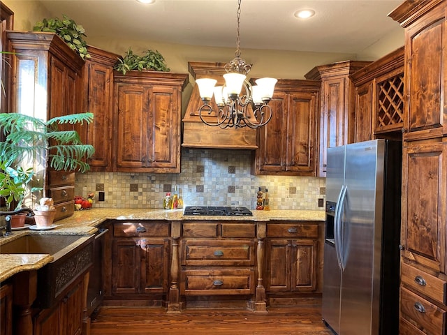 kitchen featuring backsplash, stainless steel fridge with ice dispenser, dark hardwood / wood-style flooring, and a notable chandelier