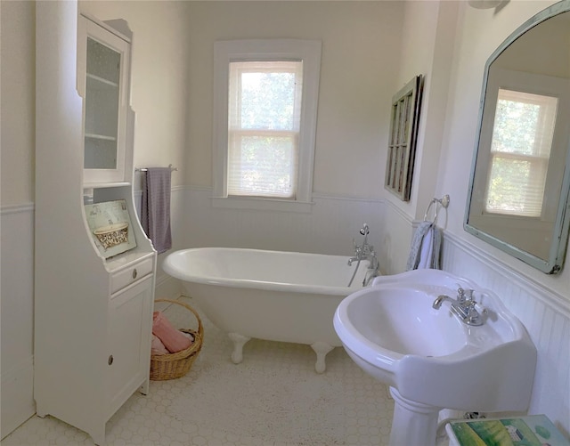 bathroom featuring tile flooring and a bath