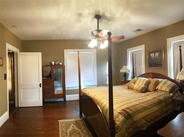 bedroom with dark hardwood / wood-style floors and ceiling fan