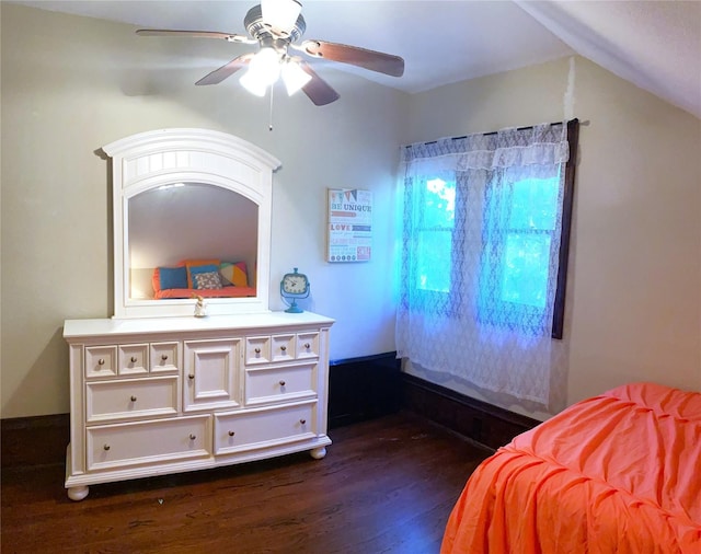 bedroom with dark hardwood / wood-style flooring, ceiling fan, and vaulted ceiling