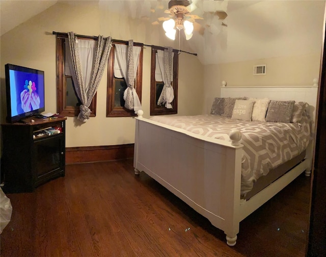 bedroom with dark hardwood / wood-style flooring, ceiling fan, and vaulted ceiling