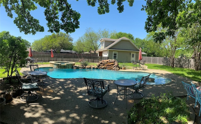 view of swimming pool featuring an in ground hot tub and a patio