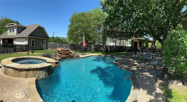 view of swimming pool featuring an in ground hot tub