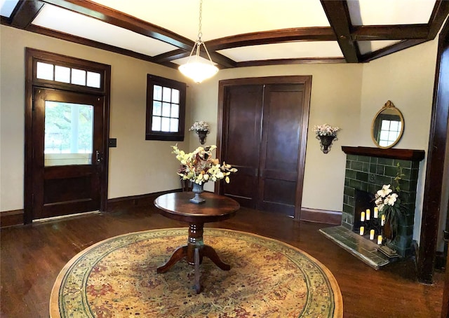 entrance foyer featuring dark hardwood / wood-style flooring, beam ceiling, a fireplace, and coffered ceiling