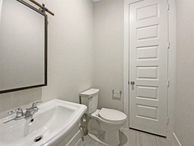 bathroom featuring toilet and sink