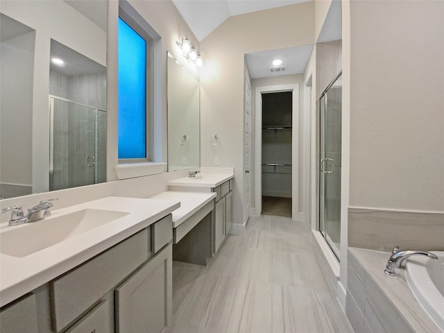 bathroom with tile flooring, double sink, plus walk in shower, and large vanity