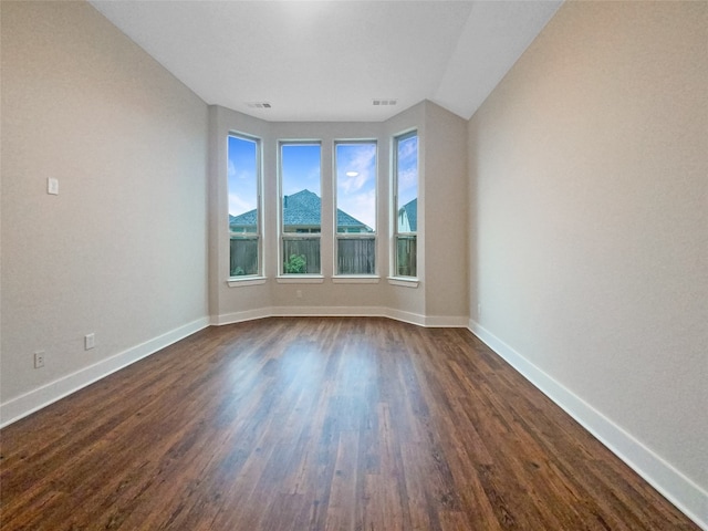 spare room with dark hardwood / wood-style flooring