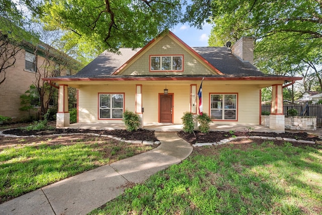 view of front of house with a porch and a front lawn